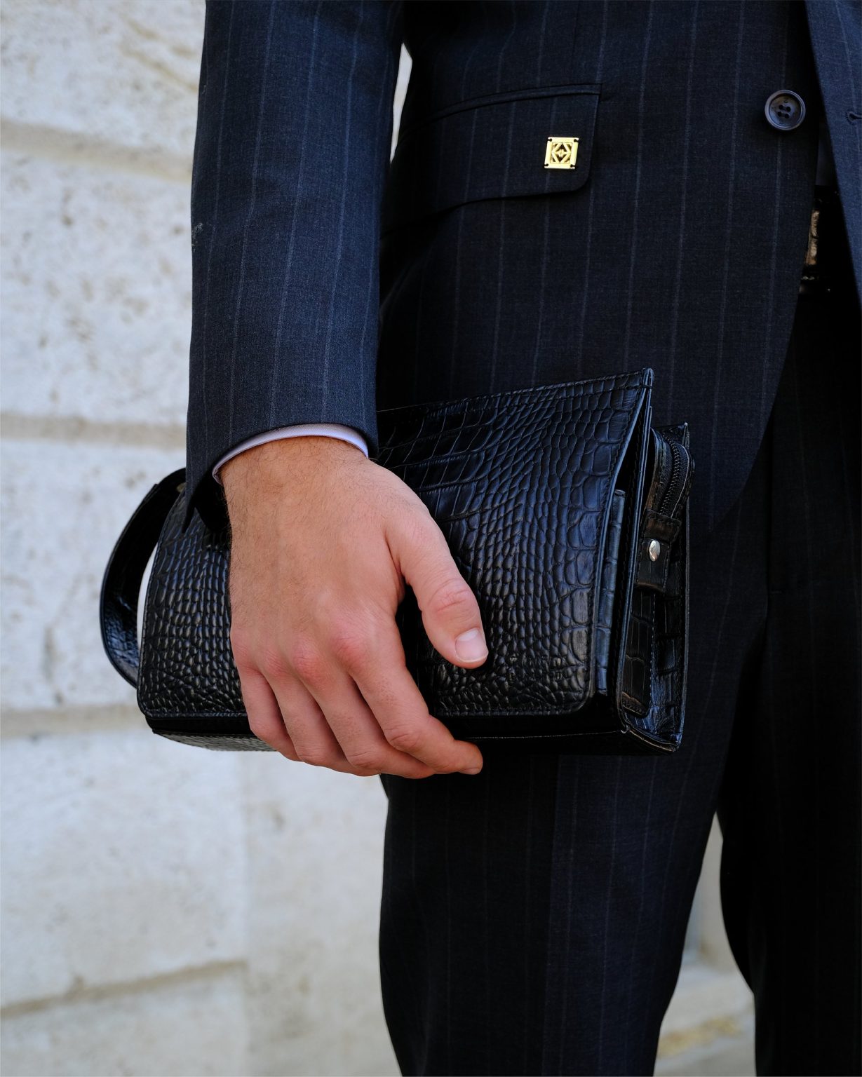 Detail – pinstripe jacket and leather clutch